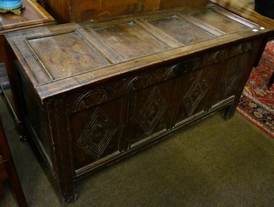 Lot 1579 - A 17th century carved oak chest with hinged lid