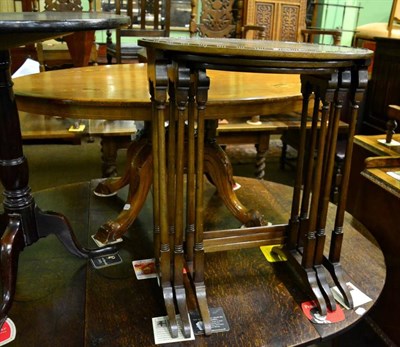 Lot 1583 - A nest of three early 20th century mahogany oval coffee tables