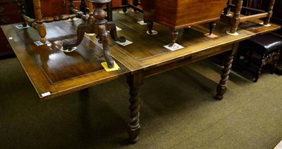 Lot 1592 - A 1920s oak draw leaf table with barley twist legs; and a matching sideboard (2)