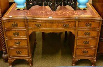 Lot 1600 - A 1930's figured walnut and leather top writing desk