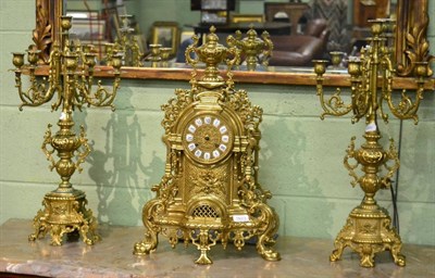 Lot 1623 - A reproduction gilt metal striking mantel clock garniture (a.f.)