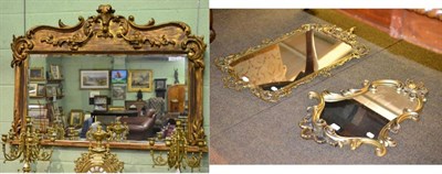 Lot 1624 - Victorian style bevel glass over mantel mirror; together with a brass rococo style mirror; and...