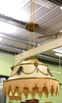 Lot 1628 - Early 20th century brass rise and fall light fitting, the shade with oval panels joined by...