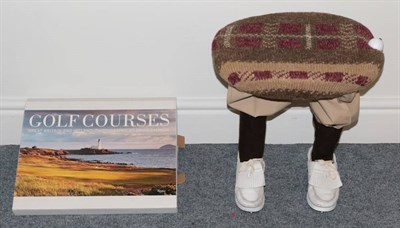 Lot 3010 - A Novelty Upholstered Stool with Golf Player Legs, together with a Book 'Golf Courses' by David...