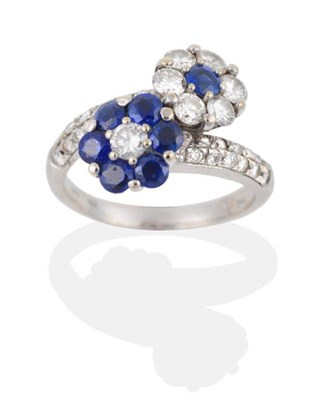 Lot 2024 - A Sapphire and Diamond Floral Cluster Crossover Ring, two flower heads set with round brilliant cut