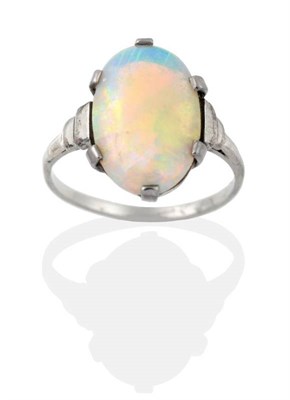 Lot 2028 - An Art Deco Opal Ring, an oval opal in a claw setting, to stepped shoulders, finger size L see...