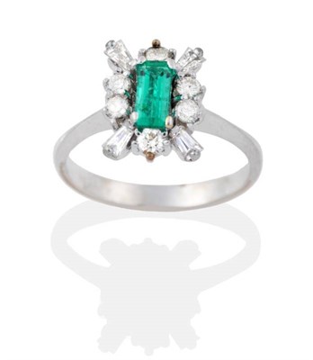 Lot 2030 - An Emerald and Diamond Cluster Ring, an octagonal cut emerald within a border of round...