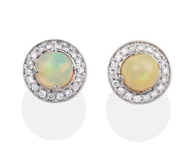 Lot 2031 - A Pair of Opal and Diamond Cluster Earrings, round opals within border of grain set round brilliant