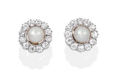 Lot 2034 - A Pearl and Diamond Cluster Earrings, single pearls within a border of old cut diamonds, total...