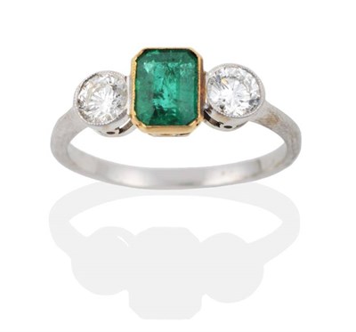 Lot 2041 - An Emerald and Diamond Three Stone Ring, a grain set octagonal cut emerald spaced by round...
