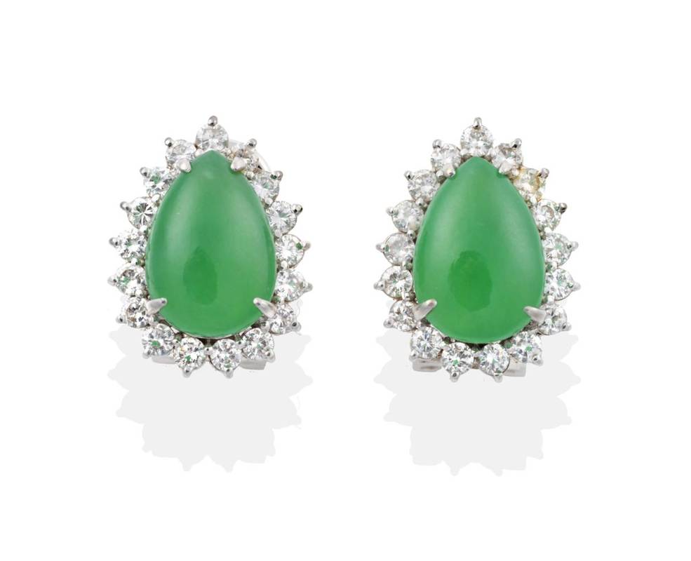 Lot 2046 - A Pair of Jade and Diamond Cluster Earrings, pear cabochon jade within borders of round...
