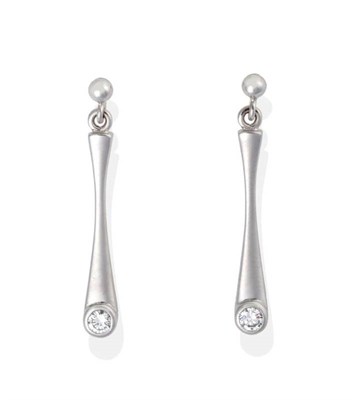 Lot 2047 - A Pair of 18 Carat White Gold Solitaire Diamond Pendant Earrings, of tapering bar drops inset...