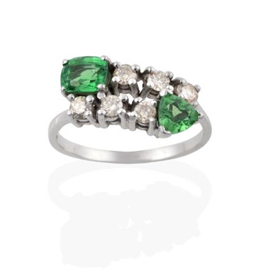 Lot 2048 - A 9 Carat White Gold Green Garnet and Diamond Crossover Ring, a cushion cut and a trilliant cut...
