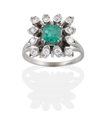 Lot 2052 - An Emerald and Diamond Cluster Ring, a square octagonal cut emerald within a border of...