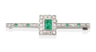 Lot 2067 - An Art Deco Emerald and Diamond Bar Brooch, an octagonal cut emerald within a rectangular border of