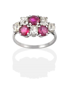 Lot 2071 - An Early Twentieth Century Ruby and Diamond Ring, of two rows of alternating old cut diamonds...