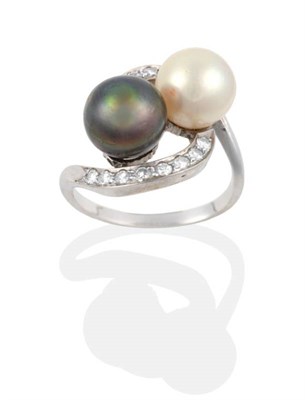 Lot 2075 - A Cultured Pearl and Diamond Crossover Ring, a black and a white cultured pearl to single-cut...