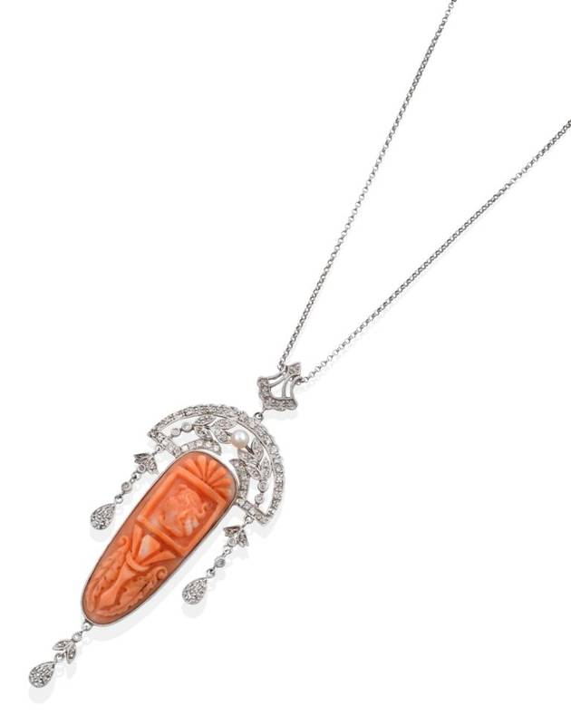 Lot 2082 - An Art Deco Style Coral and Diamond Pendant, on Chain, a carved coral plaque depicting a bust...