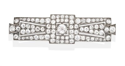 Lot 2083 - An Art Deco Diamond Brooch, a central old cut diamond in a square grain setting, within a...