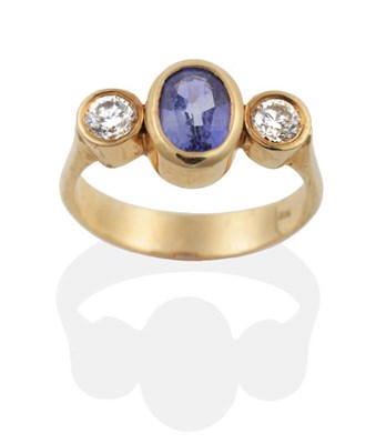 Lot 2091 - A Sapphire and Diamond Three Stone Ring, an oval cut sapphire spaced by round brilliant cut...