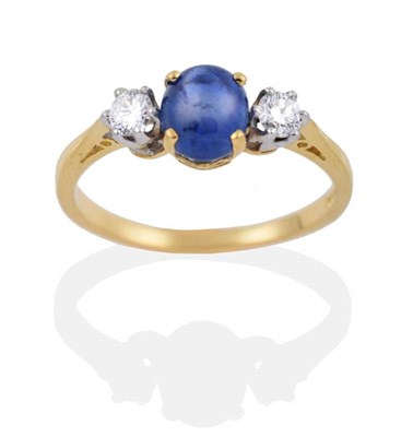 Lot 2096 - An 18 Carat Gold Star Sapphire and Diamond Three Stone Ring, an oval cut star sapphire spaced...