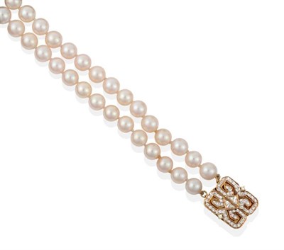 Lot 2107 - A Double Strand Cultured Pearl Necklace, with a Diamond Set Clasp, uniform cultured pearls...