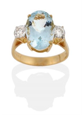 Lot 2110 - An 18 Carat Gold Aquamarine and Diamond Three Stone Ring, an oval cut aquamarine spaced by...