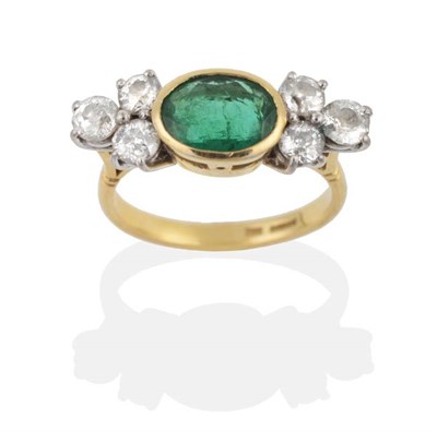 Lot 2113 - An 18 Carat Gold Emerald and Diamond Ring, an oval cut emerald in a rubbed over setting and...