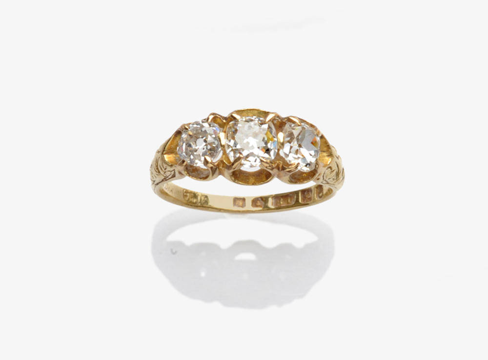 Lot 347 - A Victorian 18 Carat Gold Diamond Three Stone Ring, three old mine cut diamonds are held in...