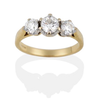 Lot 2138 - An 18 Carat Gold Three Stone Diamond Ring, graduated round brilliant cut diamonds in claw settings