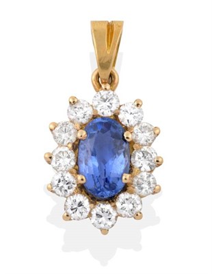 Lot 2147 - A Sapphire and Diamond Cluster Pendant, an oval cut sapphire within a border of round brilliant cut