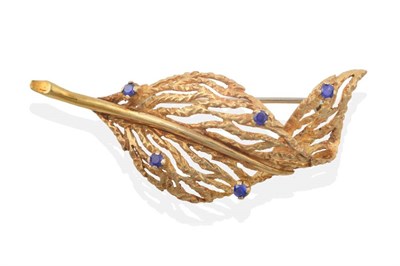 Lot 2153 - An 18 Carat Gold Sapphire Leaf Brooch by Tiffany & Co, of pierced and textured form and set...