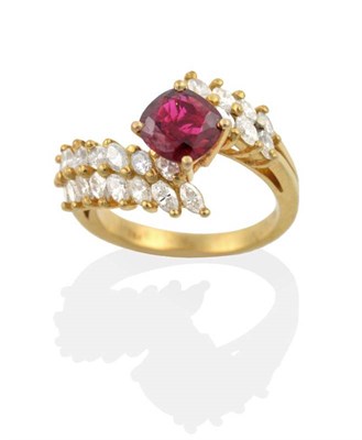 Lot 2160 - A Ruby and Diamond Ring, a cushion cut ruby in a claw setting, to marquise cut diamond set...