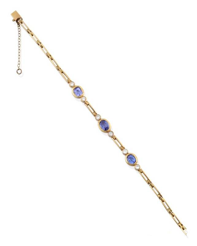 Lot 2161 - A Tanzanite and Diamond Bracelet, an oval cut tanzanite spaced by round brilliant cut diamonds with