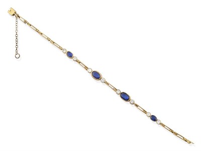 Lot 2163 - A Sapphire and Diamond Bracelet, four graduated oval cut sapphires spaced by round brilliant...