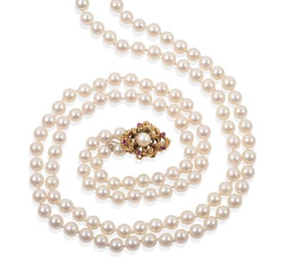 Lot 2166 - A 1970s Double Strand Cultured Pearl Necklace, with a Pearl and Ruby Set Clasp, uniform...