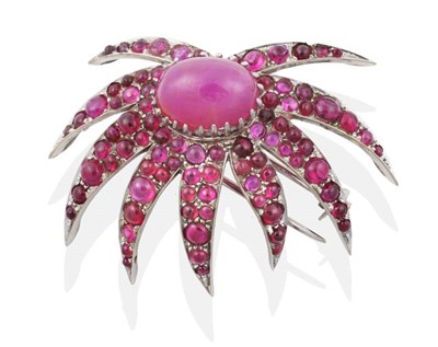 Lot 2178 - A Ruby Spray Brooch, an oval cabochon ruby in a claw setting within a border of cabochon ruby...