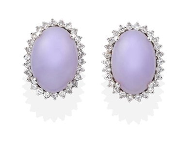 Lot 2184 - A Pair of Lavender Jade and Diamond Cluster Earrings, oval lavender jade within borders of...