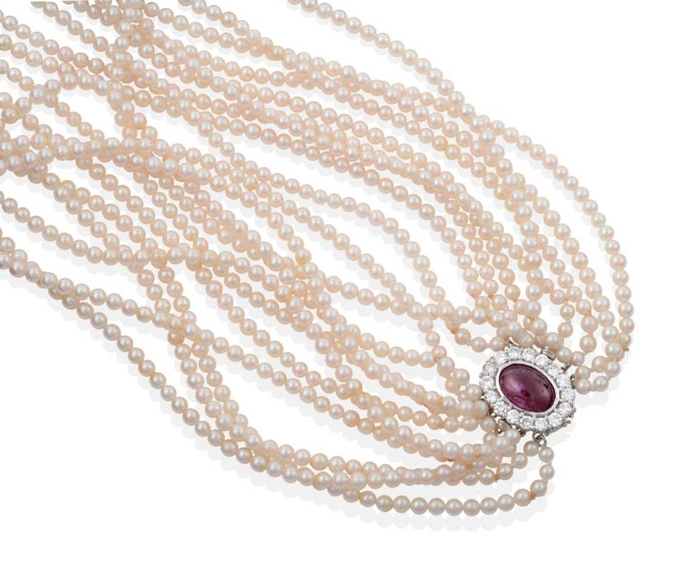 Lot 2187 - A Multi-Strand Cultured Pearl Necklace, with a Ruby and Diamond Clasp, ten strands of uniform...