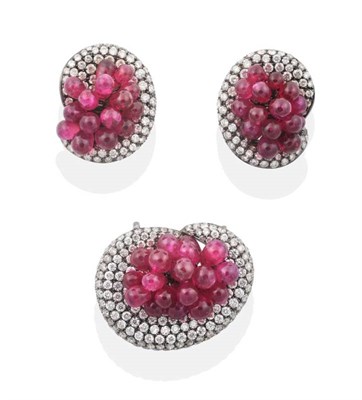 Lot 2188 - A Titanium Plated Ruby and Diamond Pendant and Earring Suite, as clusters of ruby beads within...