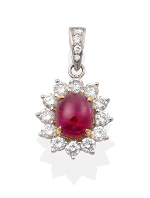Lot 2190 - A Ruby and Diamond Pendant, an oval cabochon ruby in a claw setting, within a border of round...