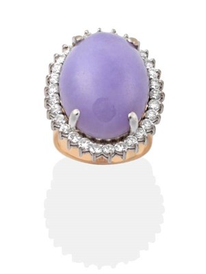 Lot 2192 - A Lavender Jade and Diamond Cluster Ring, an oval lavender jade within a border of round...