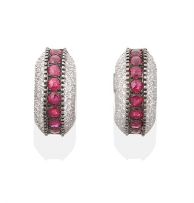 Lot 2193 - A Pair of Ruby and Diamond Hoop Earrings, by Mouawad, a row of round cut rubies between bands...