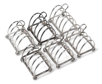 Lot 2275 - A Matched Set of Six Silver Toast Racks, three Horace Woodward & Co, London 1906/07; and three...