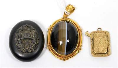 Lot 6 - A Victorian banded agate locket (a.f.); a vulcanite locket (a.f.) and a mourning locket (3)