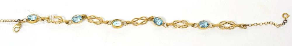 Lot 41 - 9 carat gold blue topaz bracelet, oval cut blue topaz in rubbed over settings, spaced by knot...