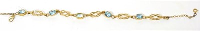 Lot 41 - 9 carat gold blue topaz bracelet, oval cut blue topaz in rubbed over settings, spaced by knot...