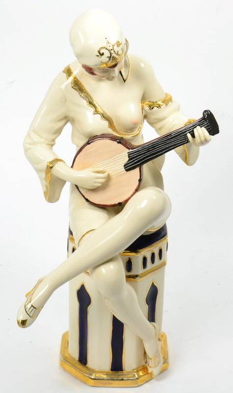 Lot 75 - A Royal Dux Art Deco figure, modelled as a semi-clad woman seated playing a mandolin, impressed...