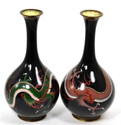 Lot 81 - A pair of cloisonne enamel vases, decorated with trailing dragons on a black ground