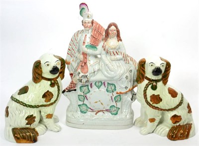 Lot 100 - A pair of luster decorated spaniels; and a large Staffordshire flat back clock group